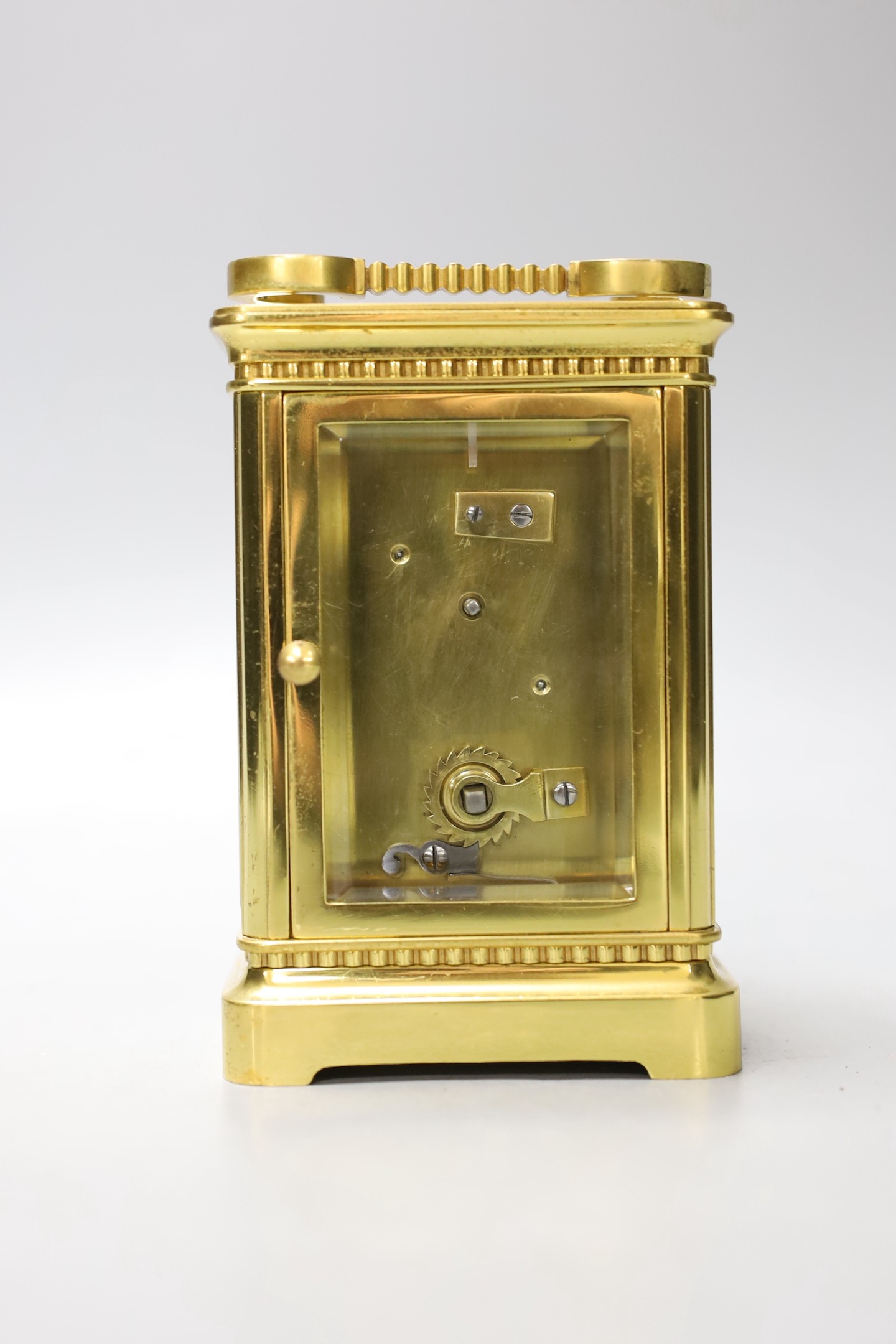 A cased French gilt brass carriage timepiece with relief cast dial and engraved presentation inscription - 14cm tall